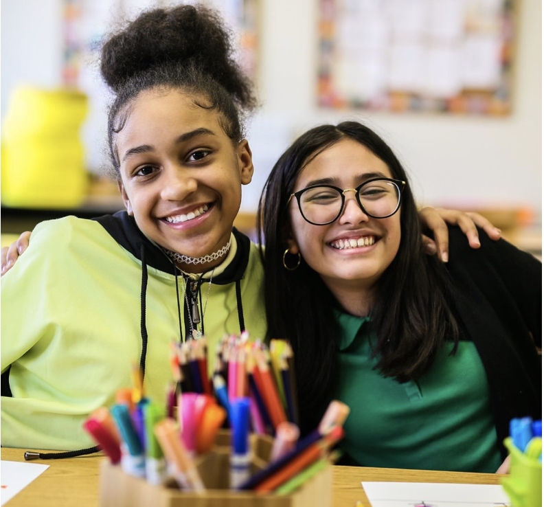 Two smiling students from Citizens of the World Charter Public School in Kansas City, MO.